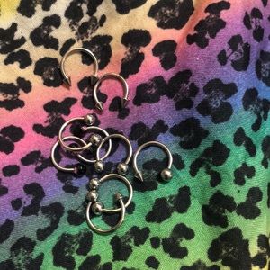 Lots of rings piercings earrings lip belly rings